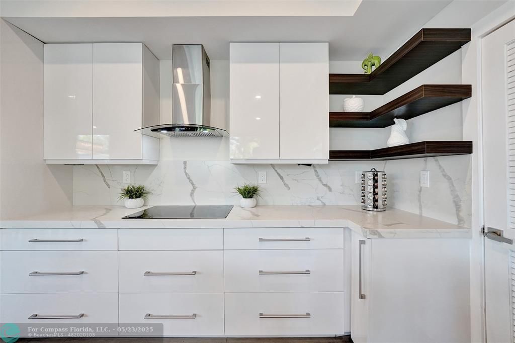 1238 Northeast 17th Avenue, Unit 2 Fort Lauderdale, FL 33304 - Photo 7 of 40 a kitchen with white cabinets and white appliances