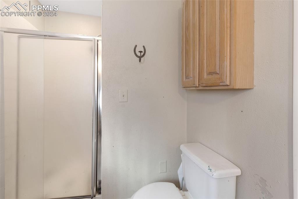 36865 Funk Road Calhan, CO 80808 - Photo 11 of 21 a white toilet sitting next to a shower
