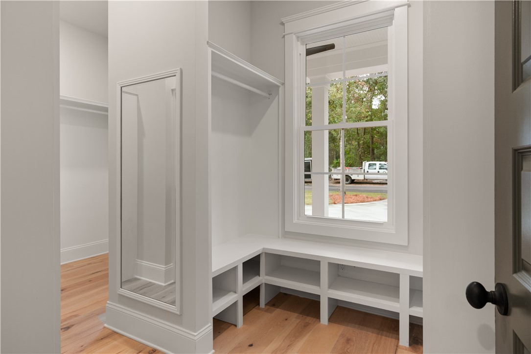 156 Rice Mill St. Simons Island, GA 31522 - Photo 18 of 36 Primary closet with seating & full length mirror