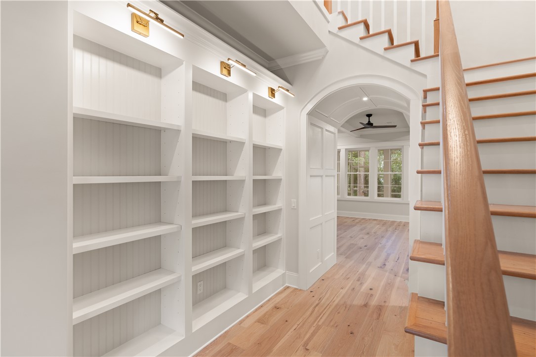 156 Rice Mill St. Simons Island, GA 31522 - Photo 3 of 36 Foyer bookshelves with picture lights