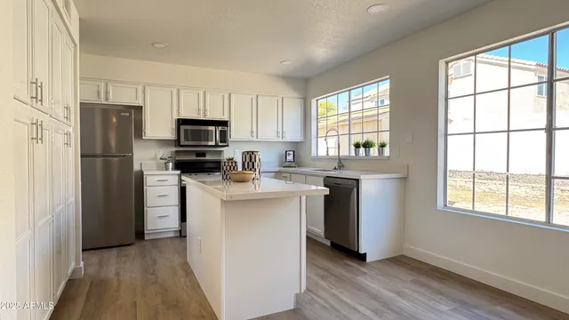 a kitchen with a refrigerator and a stove top oven