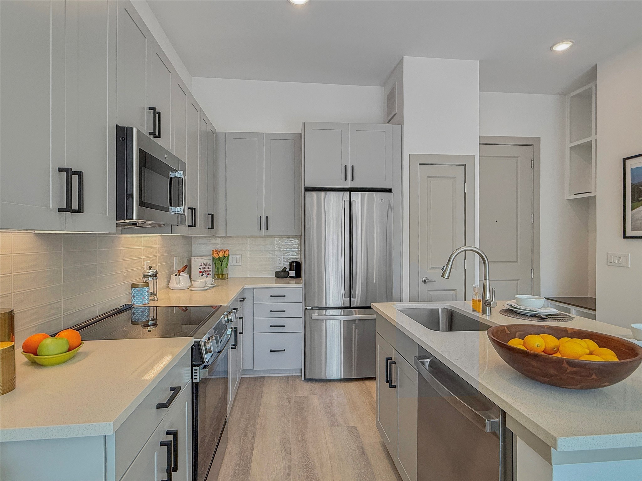 170 Malone Street, Unit 3401 Houston, TX 77007 - Photo 4 of 28 Modern chef-inspired kitchen featuring sleek quartz countertops, stainless steel appliances, soft-close cabinetry, and a spacious island perfect for cooking and entertaining. Bright, polished, and designed with style in mind.