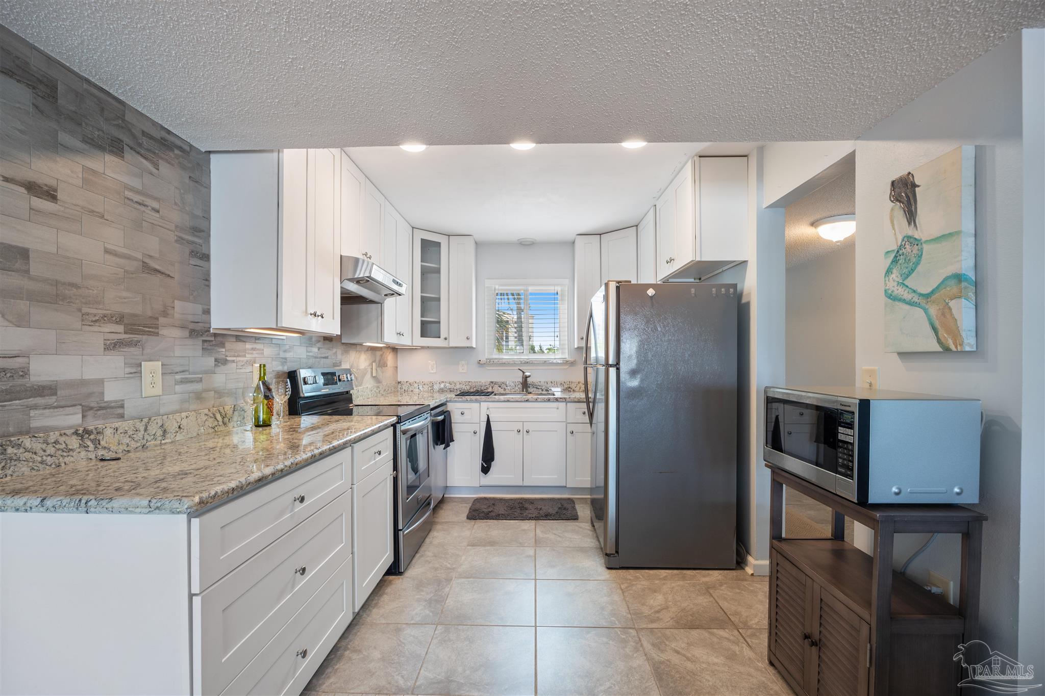 14100 River Road, Unit 228B Pensacola, FL 32507 - Photo 11 of 41 a kitchen with a refrigerator sink and microwave