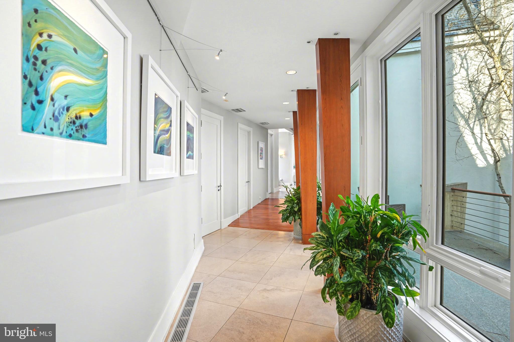 1100 Crest Lane McLean, VA 22101 - Photo 29 of 49 a view of a hallway with wooden floor and a potted plant