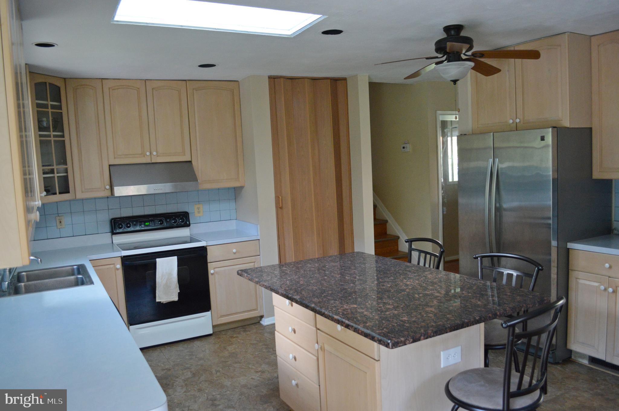 5953 Kedron Street Springfield, VA 22150 - Photo 3 of 28 a kitchen with stainless steel appliances granite countertop a sink and a refrigerator