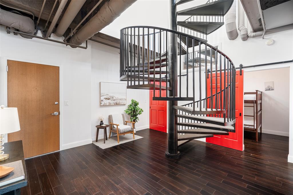511 North Akard Street, Unit 1502 Dallas, TX 75201 - Photo 5 of 30 511 N Akard #1502 is an Industrial feel penthouse with a spiral staircase leading to terrace level and 3rd bedroom (or flex space)