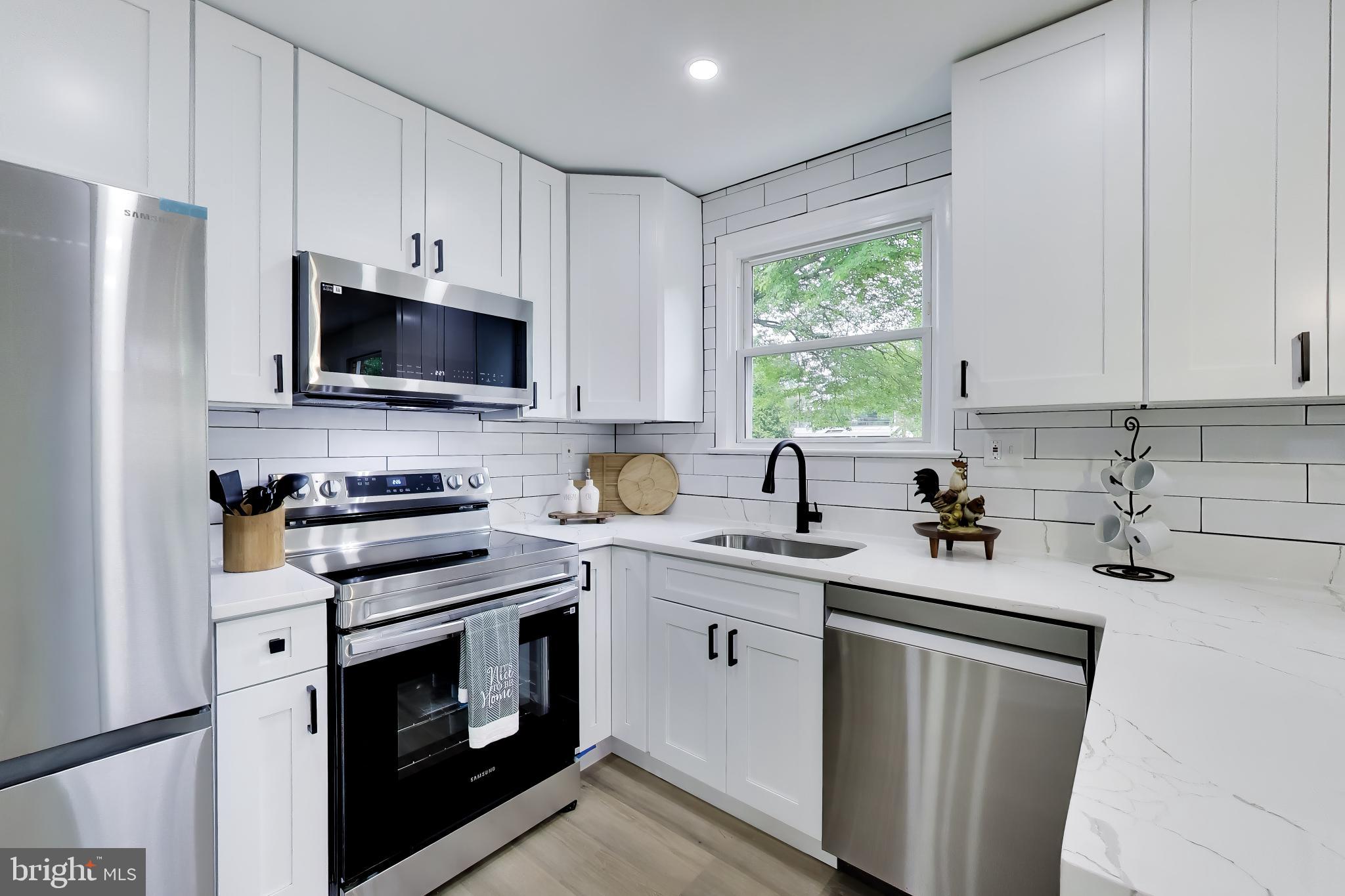 11309 Keystone Avenue Clinton, MD 20735 - Photo 10 of 36 a kitchen with a sink stove and microwave