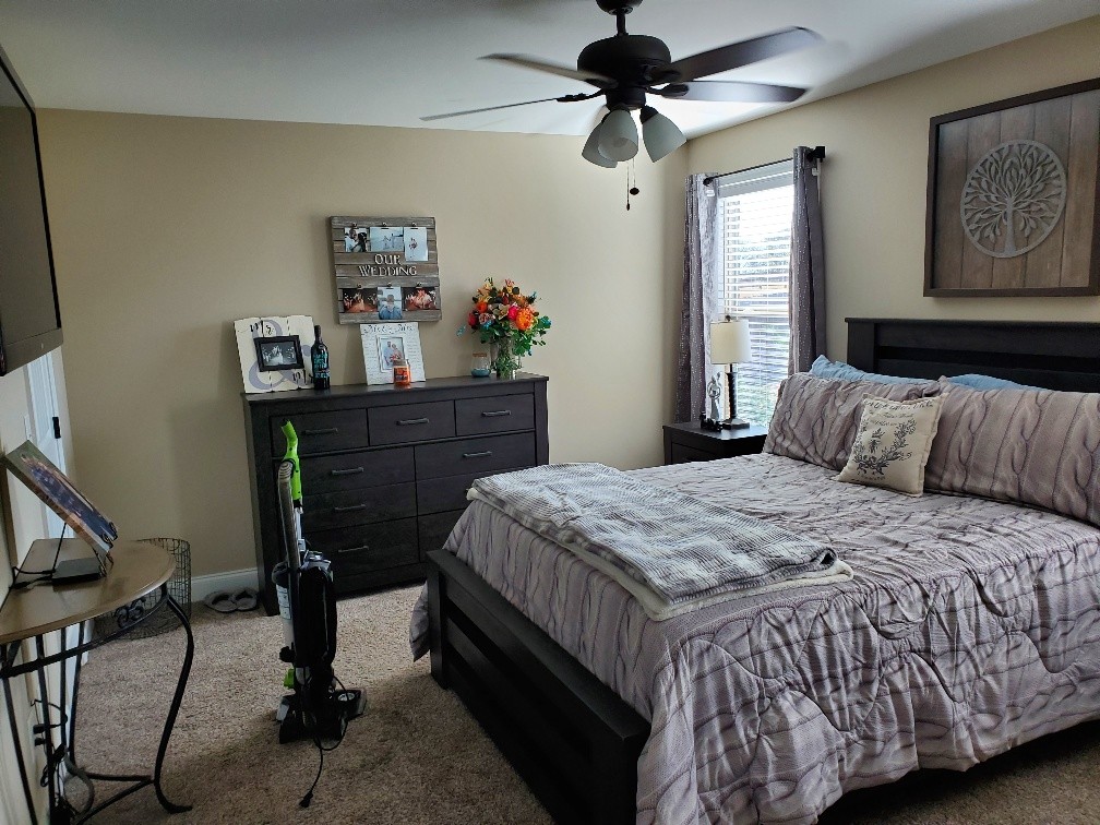 164 Ben Armstrong Road Castalian Springs, TN 37031 - Photo 14 of 22 a bedroom with a bed and a chandelier