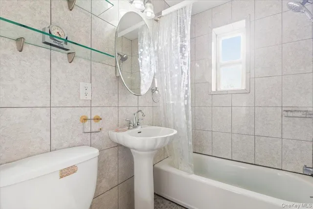 a bathroom with a sink a bathtub and shower