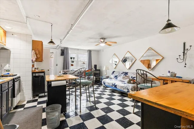 a kitchen with a sink a stove a dining table and chairs