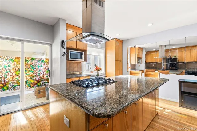 a kitchen with counter top space and windows