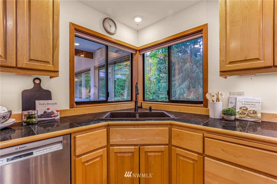 17418 Southeast 106th Street Renton, WA 98059 - Photo 11 of 39 a kitchen with granite countertop a sink and a window