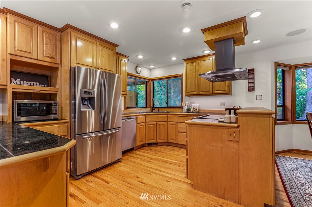 17418 Southeast 106th Street Renton, WA 98059 - Photo 12 of 39 a kitchen with stainless steel appliances granite countertop a refrigerator a stove and a sink