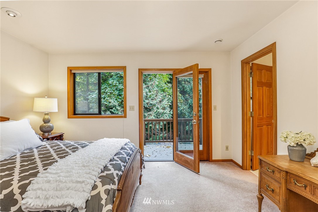 17418 Southeast 106th Street Renton, WA 98059 - Photo 16 of 39 a bedroom with a large bed and a window