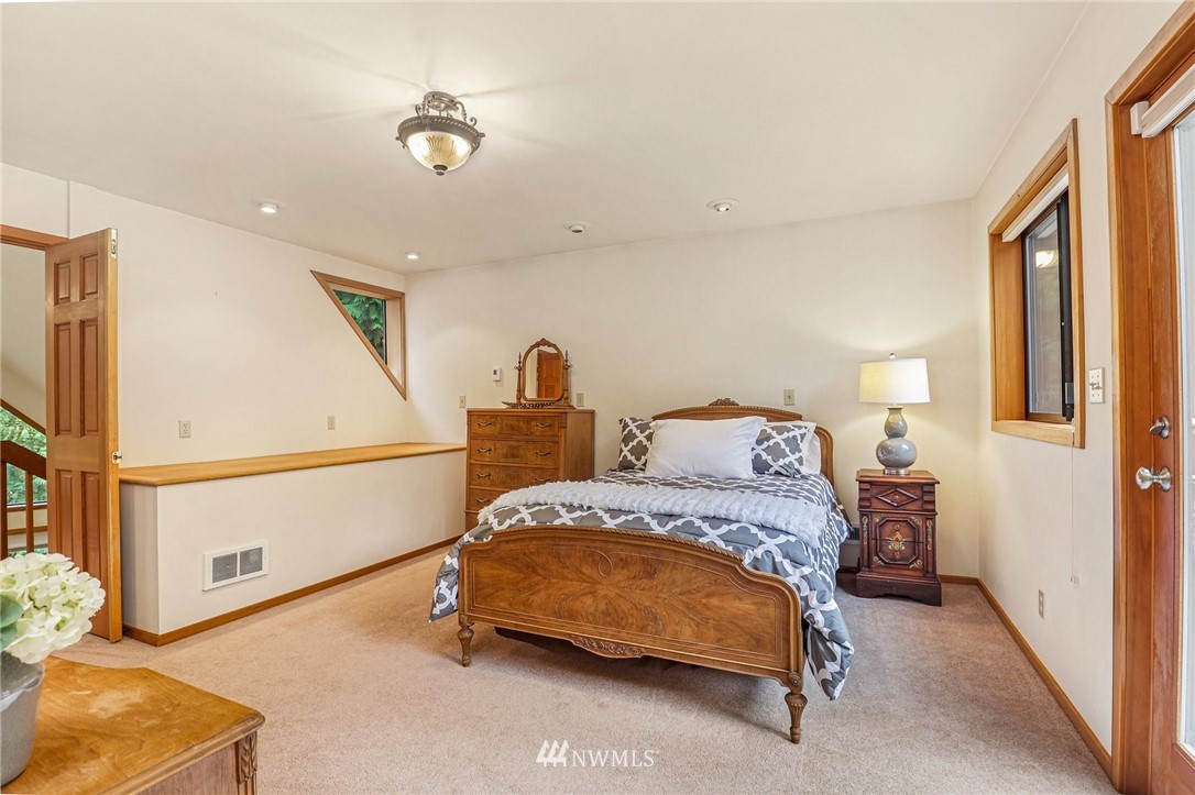 17418 Southeast 106th Street Renton, WA 98059 - Photo 17 of 39 a bedroom with a bed and a lamp with the wooden floor