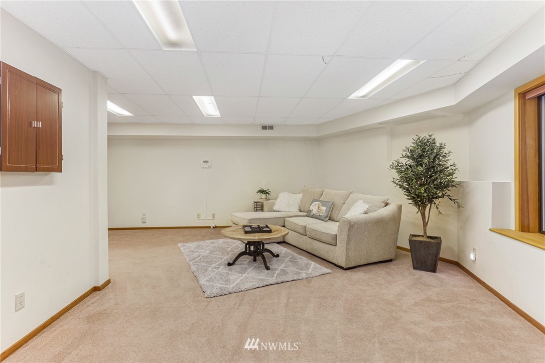 17418 Southeast 106th Street Renton, WA 98059 - Photo 21 of 39 a living room with furniture and a potted plant