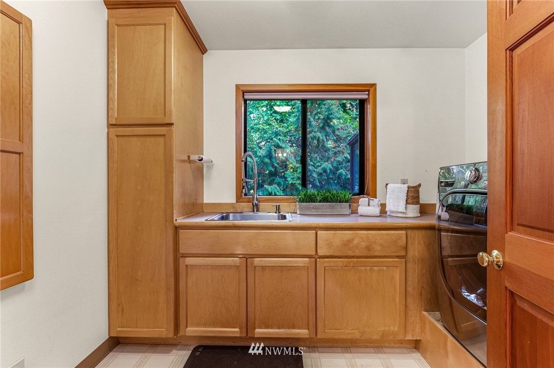 17418 Southeast 106th Street Renton, WA 98059 - Photo 24 of 39 a kitchen with stainless steel appliances a sink and a window