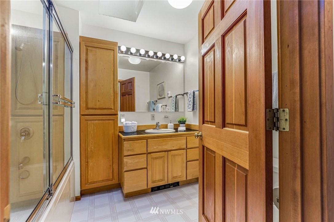 17418 Southeast 106th Street Renton, WA 98059 - Photo 25 of 39 a bathroom with a double vanity sink mirror and shower