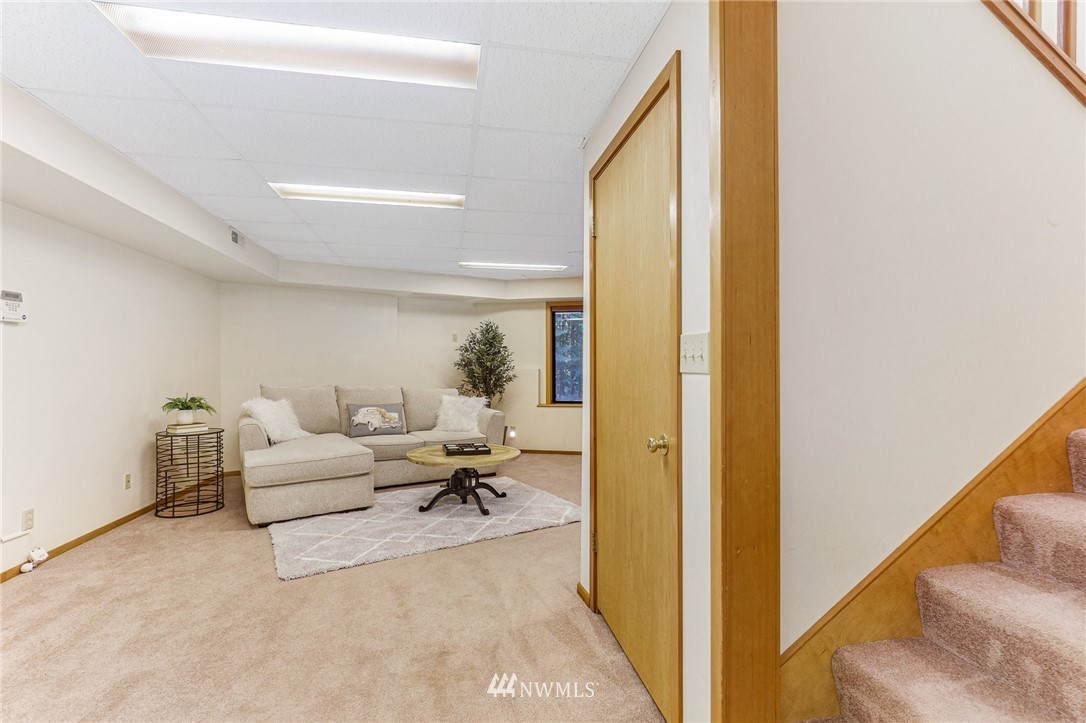 17418 Southeast 106th Street Renton, WA 98059 - Photo 27 of 39 a living room with furniture and a large window