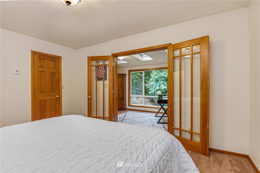 17418 Southeast 106th Street Renton, WA 98059 - Photo 29 of 39 a bedroom with a bed and a large window