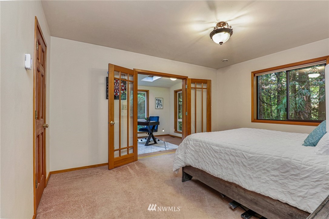 17418 Southeast 106th Street Renton, WA 98059 - Photo 31 of 39 a bedroom with a bed and a chandelier