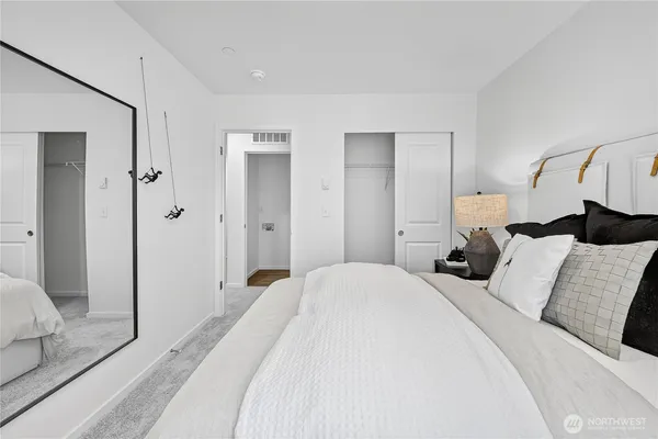 a bedroom with a bed and a mirror