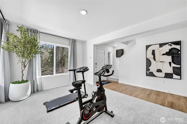 a view of a room with gym equipment and floor to ceiling window