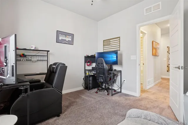 a view of a livingroom with workspace and a couch
