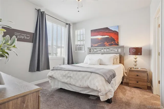 a bedroom with a bed and a large mirror