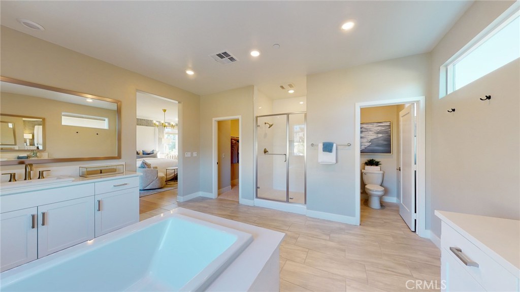 246 Chorus Irvine, CA 92618 - Photo 4 of 75 a spacious bathroom with a shower a sink and a mirror