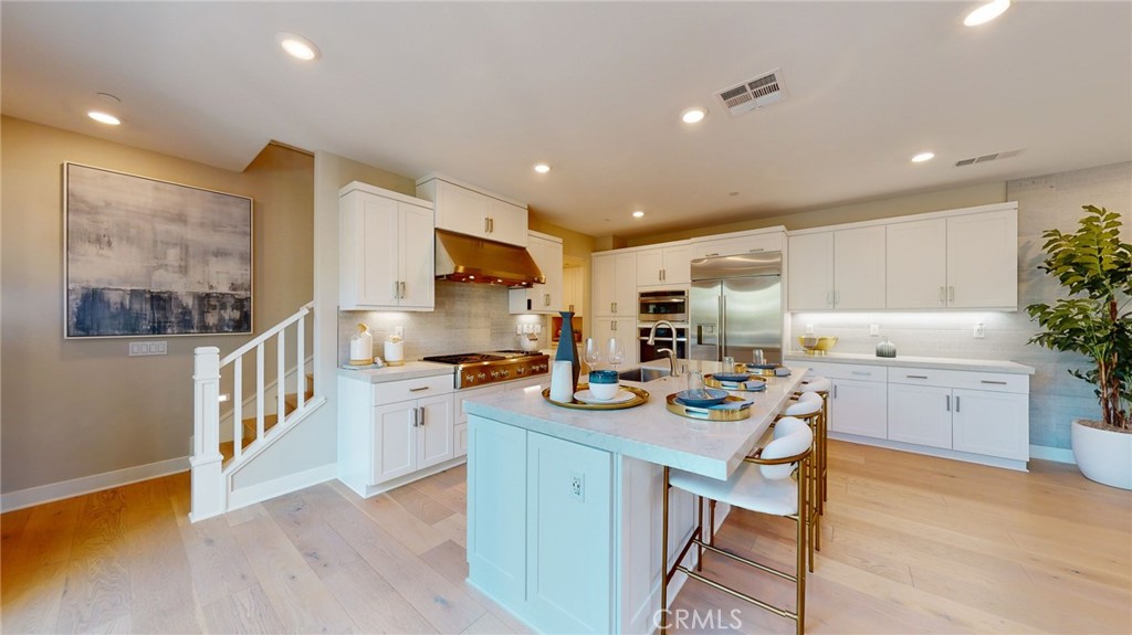 246 Chorus Irvine, CA 92618 - Photo 43 of 75 a kitchen with a sink a stove a refrigerator cabinets and wooden floor