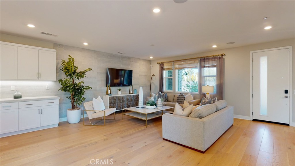 246 Chorus Irvine, CA 92618 - Photo 47 of 75 a living room with furniture a flat screen tv and a large window