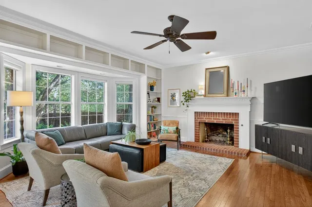 a living room with furniture a flat screen tv and a fireplace