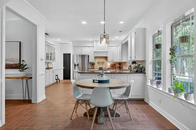 a kitchen with stainless steel appliances kitchen island a large island in the center and cabinets