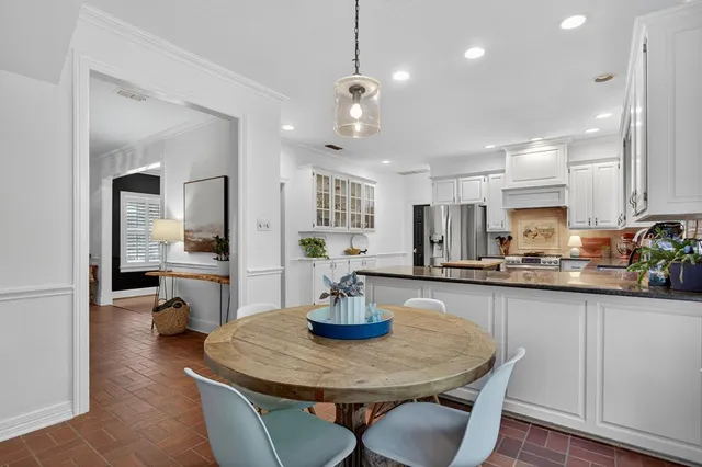a kitchen with a table and chairs in it
