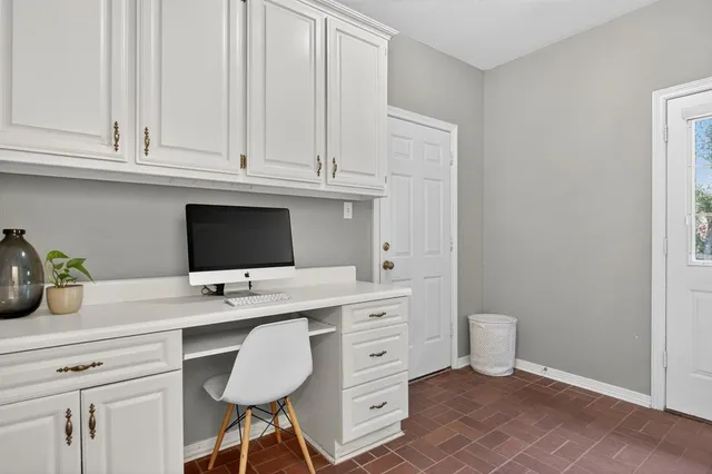 a workstation with a sink and cabinets