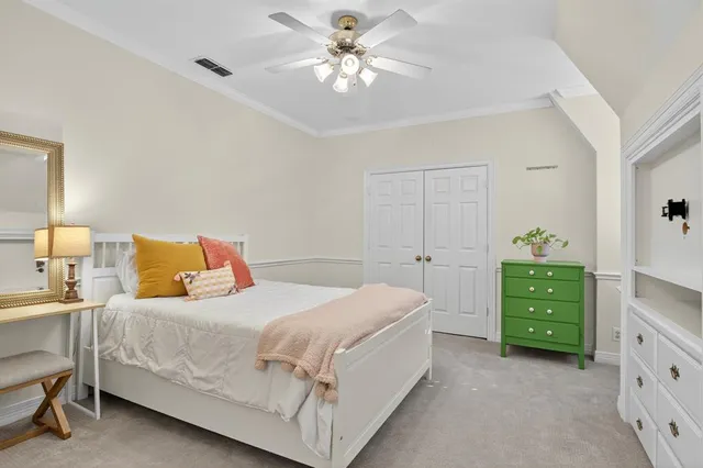 a bedroom with a bed and a dresser