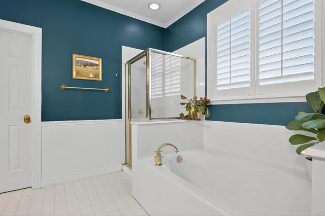 a bathroom with bathtub and window