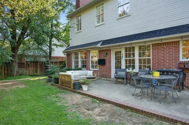 a view of a house with backyard sitting area and garden