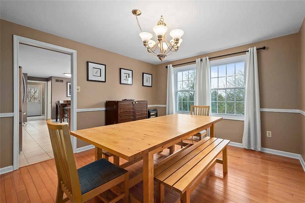 1550 Hastings Mill Road Pittsburgh, PA 15241 - Photo 7 of 25 a view of a dining room with furniture a chandelier and wooden floor