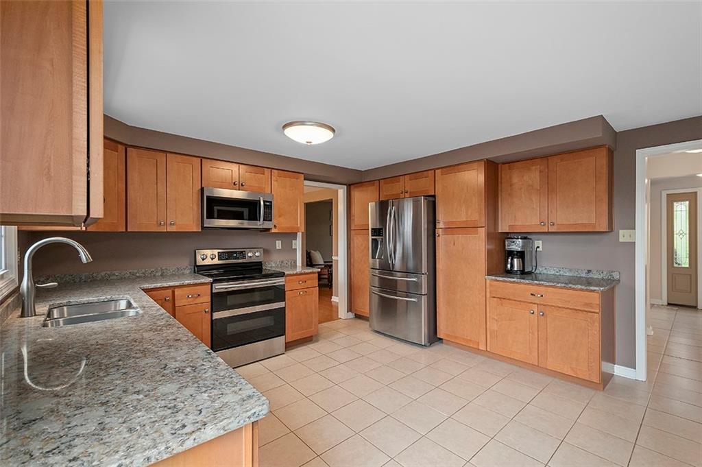 1550 Hastings Mill Road Pittsburgh, PA 15241 - Photo 9 of 25 a kitchen with stainless steel appliances granite countertop a stove sink and refrigerator