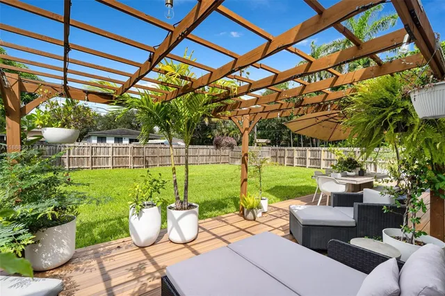 a view of a patio with couches chairs and a potted plant
