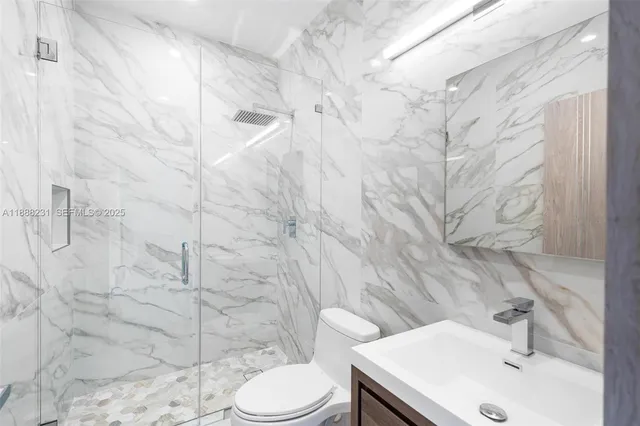 a bathroom with a sink toilet and shower