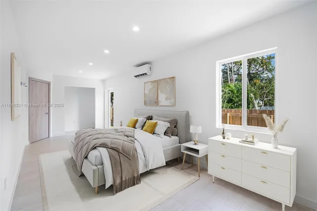 a spacious bedroom with a bed and a window