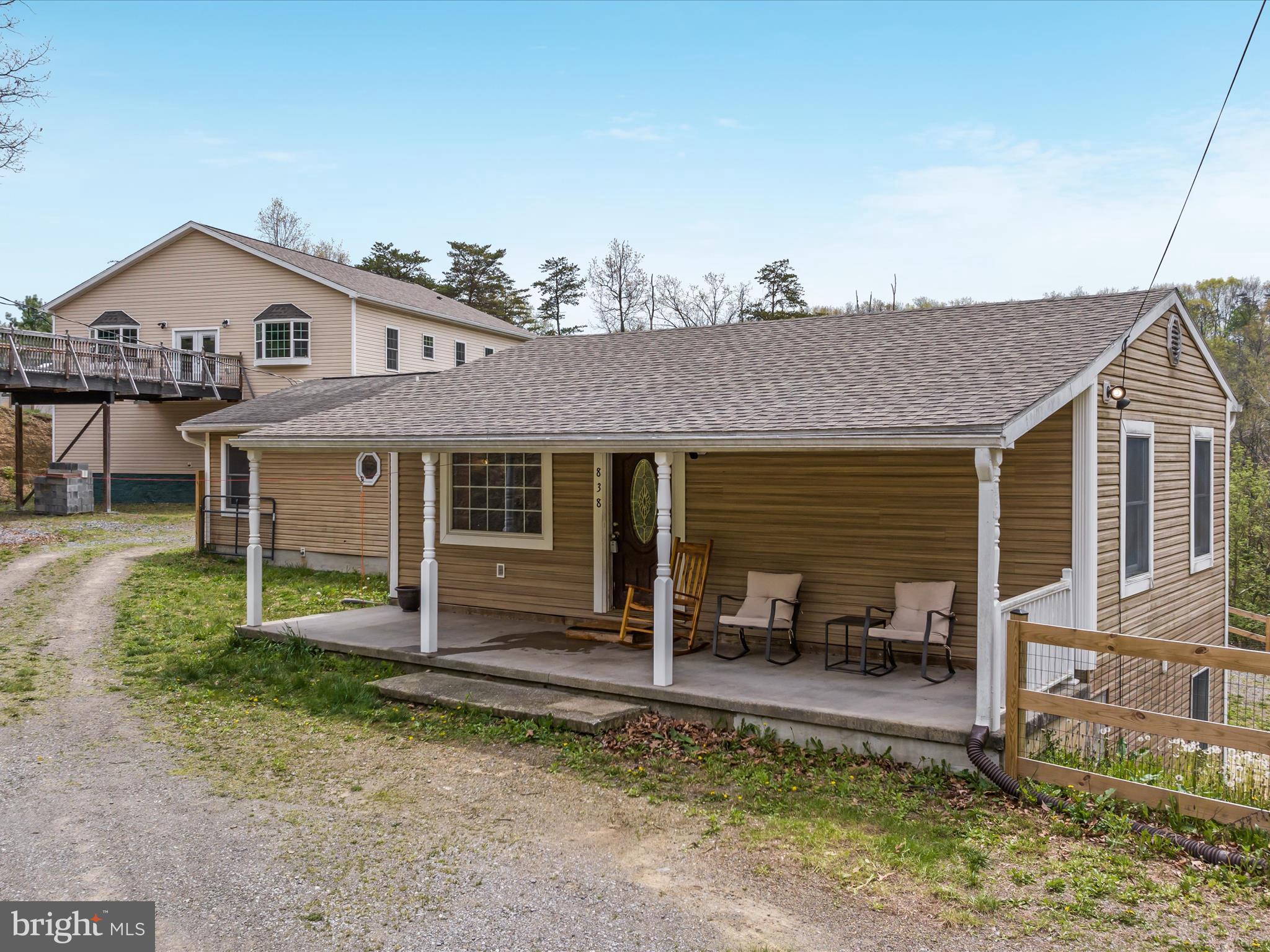838 Dollar Lane Bunker Hill, WV 25413 - Photo 2 of 68 a view of a house with a patio and a yard