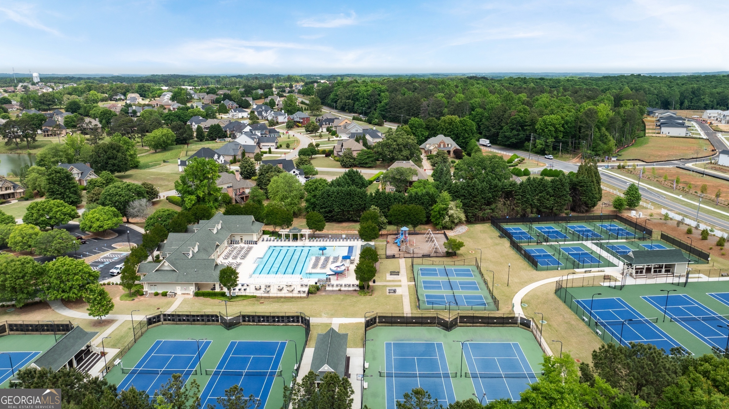 15 Overview Court Hoschton, GA 30548 - Photo 4 of 43 an aerial view of a house with a garden and lake view