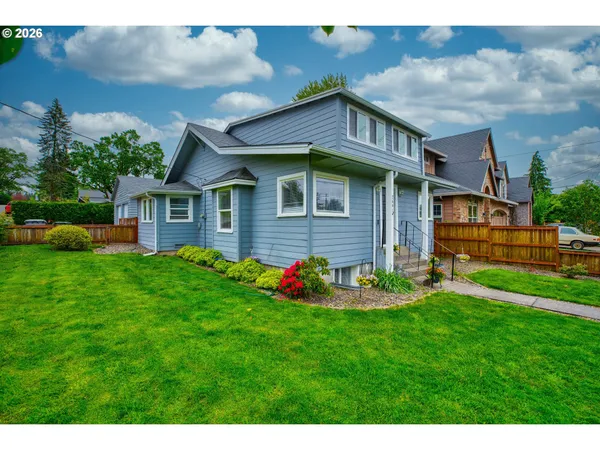 a front view of house with yard and green space