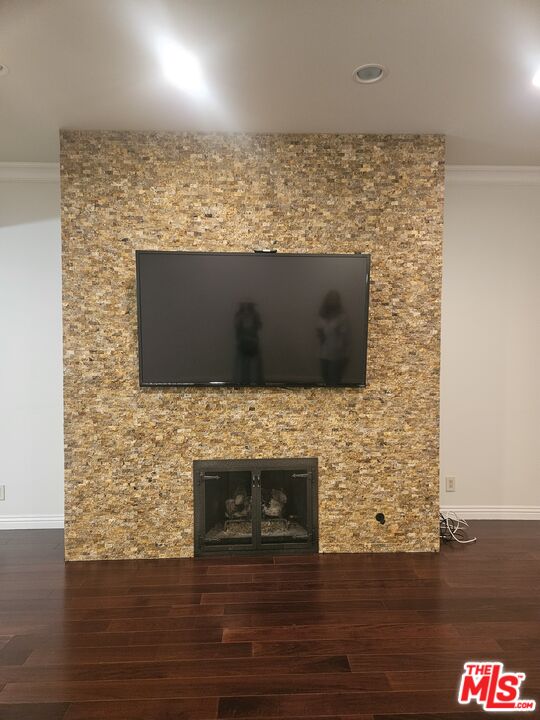 1880 Veteran Avenue, Unit 107 Los Angeles, CA 90025 - Photo 4 of 26 a view of empty room with wooden floor and fireplace