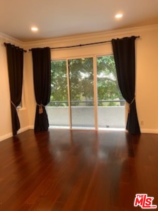 1880 Veteran Avenue, Unit 107 Los Angeles, CA 90025 - Photo 10 of 26 a view of a room with wooden floor and a window