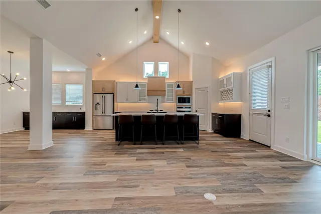 a view of kitchen and kitchen with granite countertop stove top oven